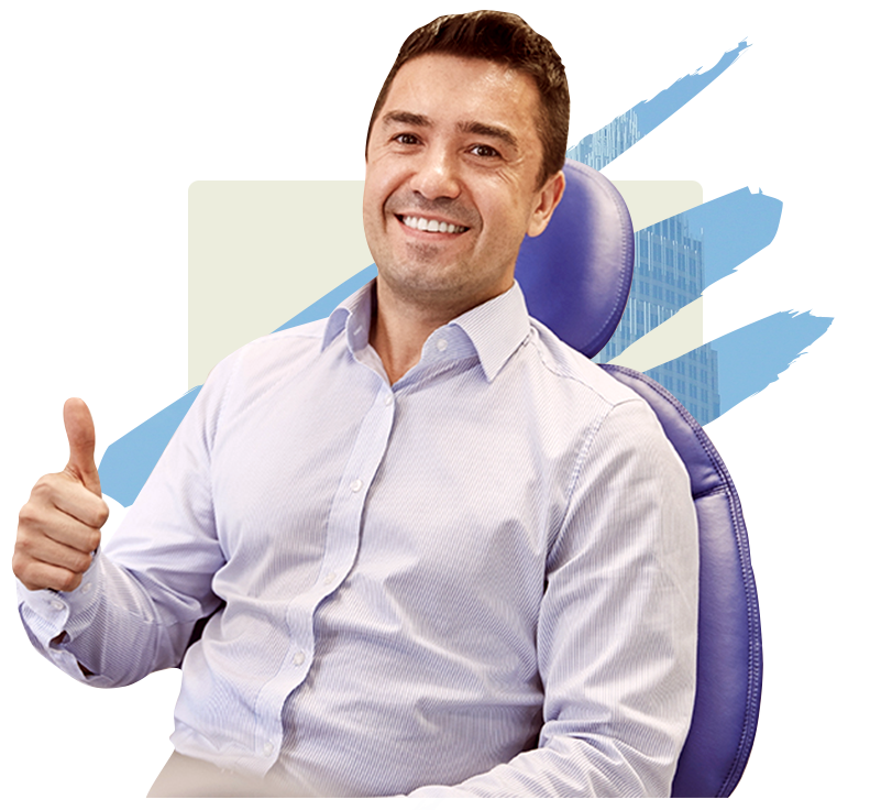 Smiling man in dental chair giving thumbs up